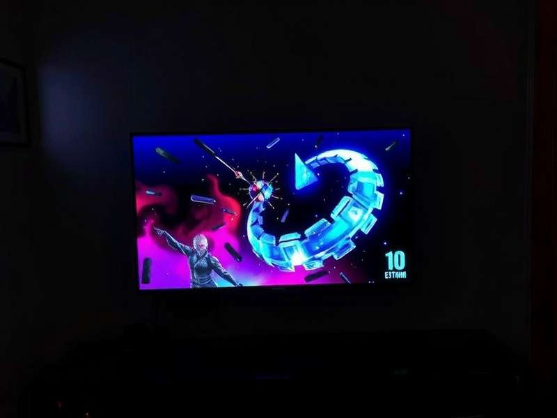 Modern living room with a laptop screen duplicated on a large TV